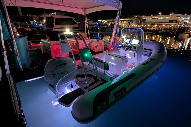 The Image of 2026 Tide Craft Sanibel 17 boat illuminated at night, docked with Tohatsu engine. - 0