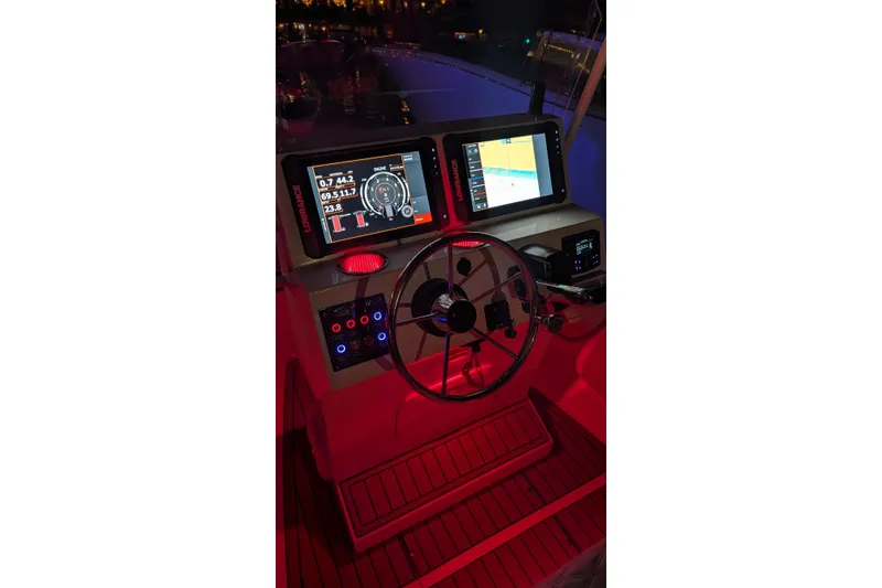 Slide: The Image of Tide Craft Sanibel 17 boat dashboard with illuminated controls and navigation screens, 2026 model. - 4