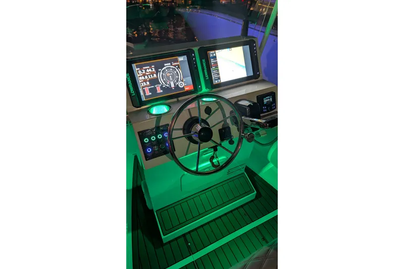 Slide: The Image of 2026 Tide Craft Sanibel 17 boat dashboard with illuminated controls and navigation screens. - 5