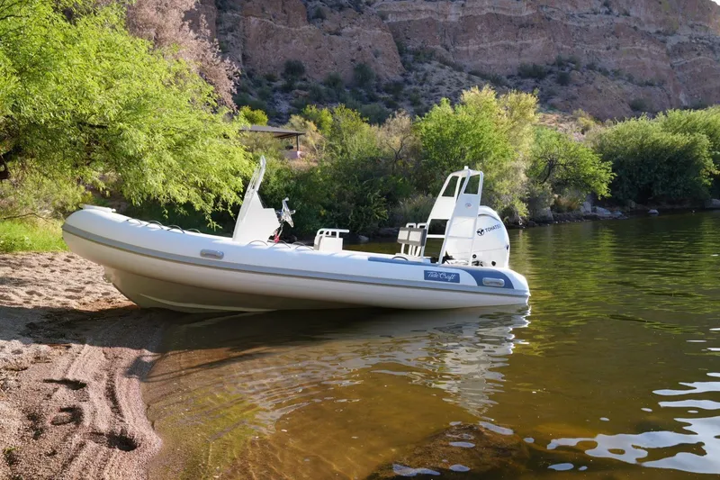 Slide: The Image of 2026 Tide Craft Sanibel 17 boat on a serene lakeside beach. - 8