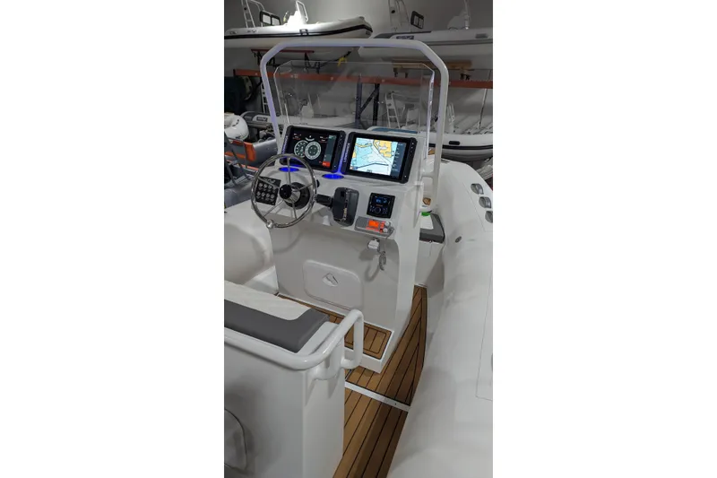 Slide: The Image of Helm of 2026 Tide Craft Sanibel 17 boat with illuminated controls and navigation screens. - 3
