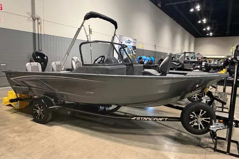 The Image of 2026 Starcraft Storm 17 DC Pro boat displayed indoors on a trailer. - 0