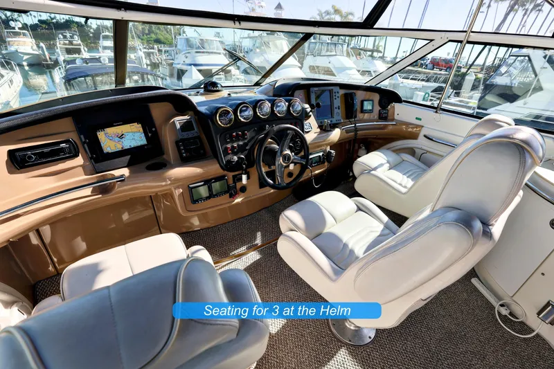 Slide: The Image of 2004 Carver 466 Motor Yacht flybridge with seating, table, and marina view. - 10