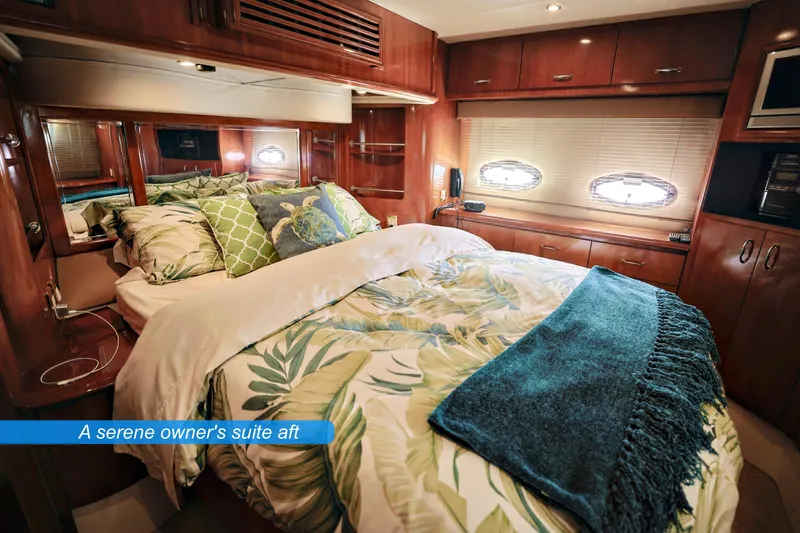 Slide: The Image of Luxurious 2004 Carver 466 Motor Yacht bedroom with elegant wood cabinetry and cozy bedding. - 21