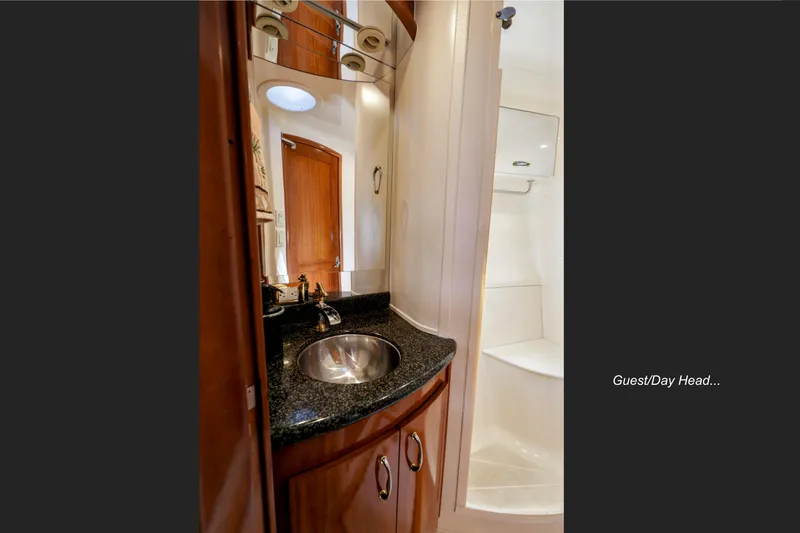 Slide: The Image of 2004 Carver 466 Motor Yacht bathroom with shower, sink, and toilet. - 26