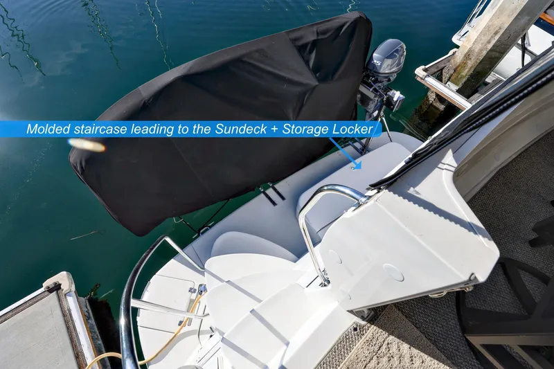 Slide: The Image of 2004 Carver 466 Motor Yacht flybridge with seating and helm, featuring panoramic marina views. - 7