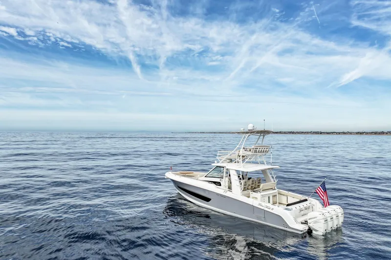 Slide: The Image of 2018 Boston Whaler 420 Outrage boat on calm ocean under blue sky. - 1