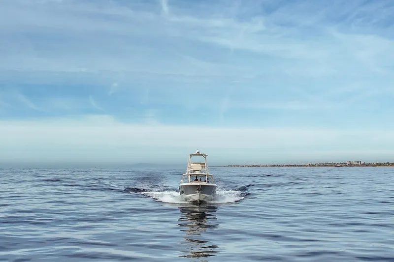 Slide: The Image of 2018 Boston Whaler 420 Outrage cruising on calm ocean under clear blue sky. - 15