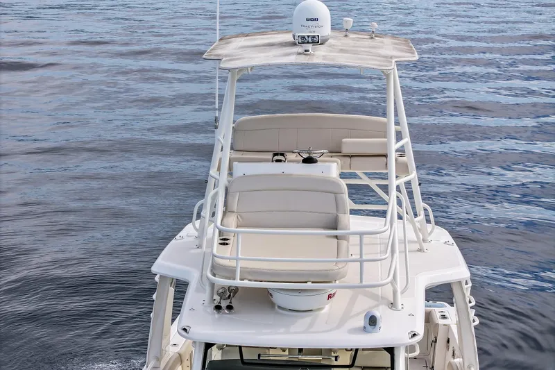 Slide: The Image of Boston Whaler 420 Outrage 2018 boat with upper deck on calm water. - 19