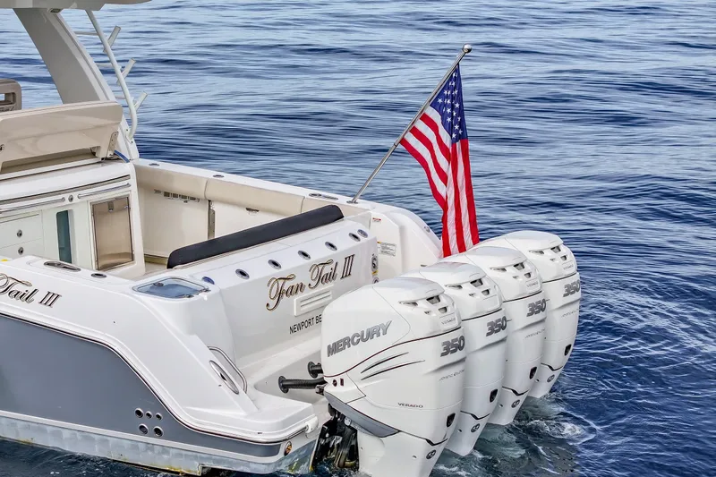 Slide: The Image of 2018 Boston Whaler 420 Outrage with four Mercury 350 engines and American flag. - 2