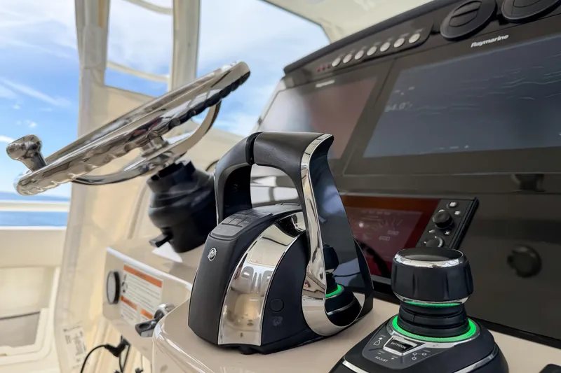 Slide: The Image of Control panel of 2018 Boston Whaler 420 Outrage with steering wheel and navigation system. - 26