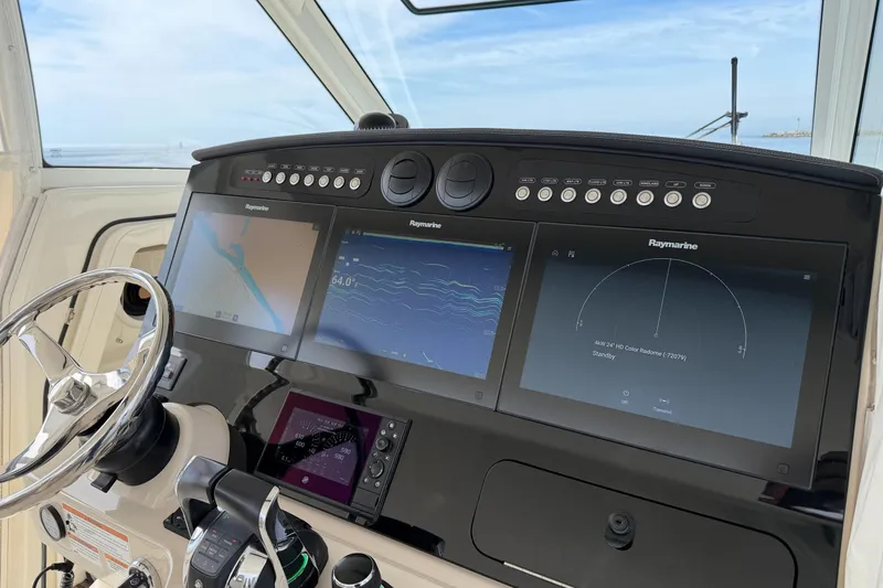 Slide: The Image of Control panel of 2018 Boston Whaler 420 Outrage with Raymarine navigation displays. - 28