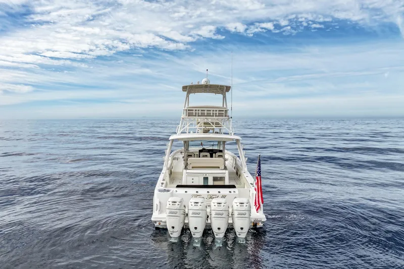 Slide: The Image of 2018 Boston Whaler 420 Outrage on open sea with American flag, clear sky. - 3