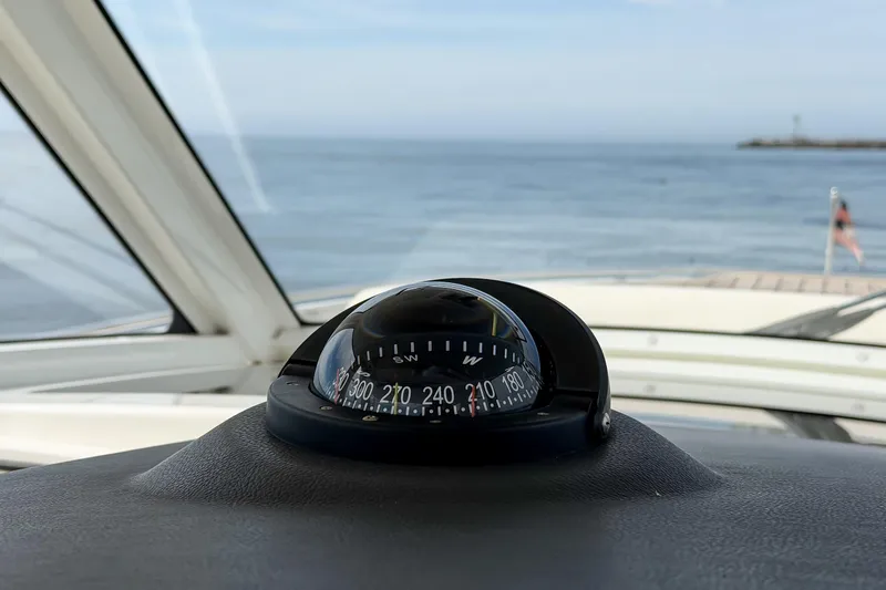 Slide: The Image of Compass on 2018 Boston Whaler 420 Outrage, overlooking calm ocean waters. - 32