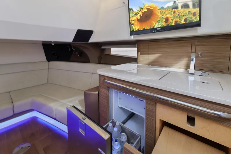 Slide: The Image of Luxurious interior of 2018 Boston Whaler 420 Outrage with seating, kitchenette, and TV. - 36