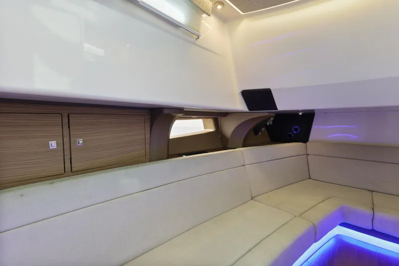 Slide: The Image of Interior of 2018 Boston Whaler 420 Outrage, featuring modern seating and ambient lighting. - 40