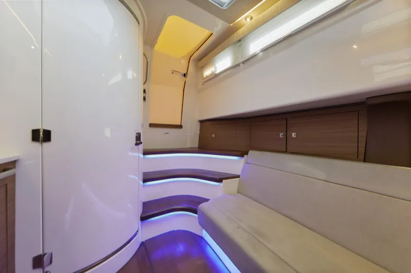 Slide: The Image of Interior of 2018 Boston Whaler 420 Outrage, featuring modern seating and ambient lighting. - 42