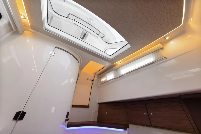 Slide: The Image of 2018 Boston Whaler 420 Outrage cabin interior with modern lighting and sleek design. - 43