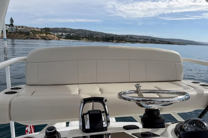 Slide: The Image of 2018 Boston Whaler 420 Outrage helm with luxurious seating and ocean view. - 51