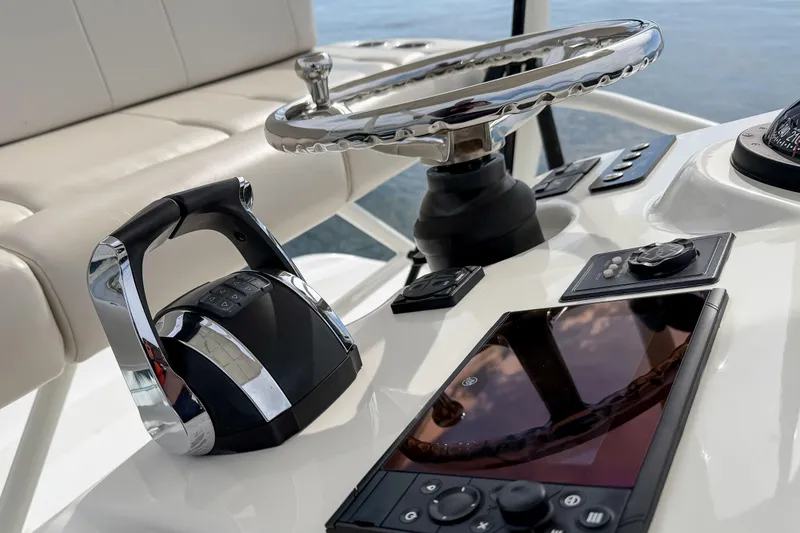 Slide: The Image of Control panel of 2018 Boston Whaler 420 Outrage boat with steering wheel and throttle. - 52