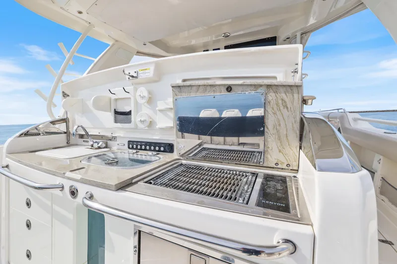 Slide: The Image of 2018 Boston Whaler 420 Outrage boat kitchen with grill and sink, ocean view. - 57
