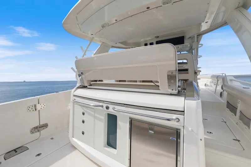 Slide: The Image of 2018 Boston Whaler 420 Outrage boat interior with seating and storage, ocean view. - 58