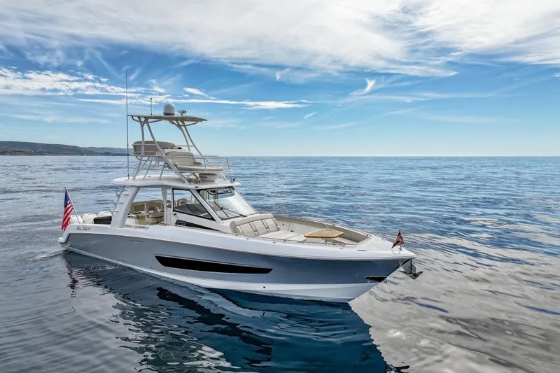Slide: The Image of 2018 Boston Whaler 420 Outrage boat on calm ocean under blue sky. - 6
