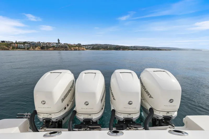 Slide: The Image of Four Mercury outboard engines on a 2018 Boston Whaler 420 Outrage, ocean view. - 60