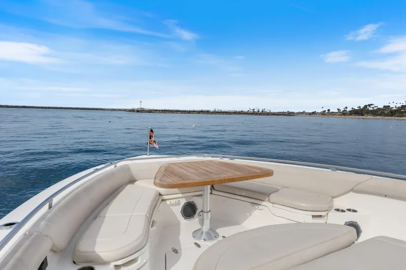 Slide: The Image of 2018 Boston Whaler 420 Outrage boat with seating and table, ocean view. - 65