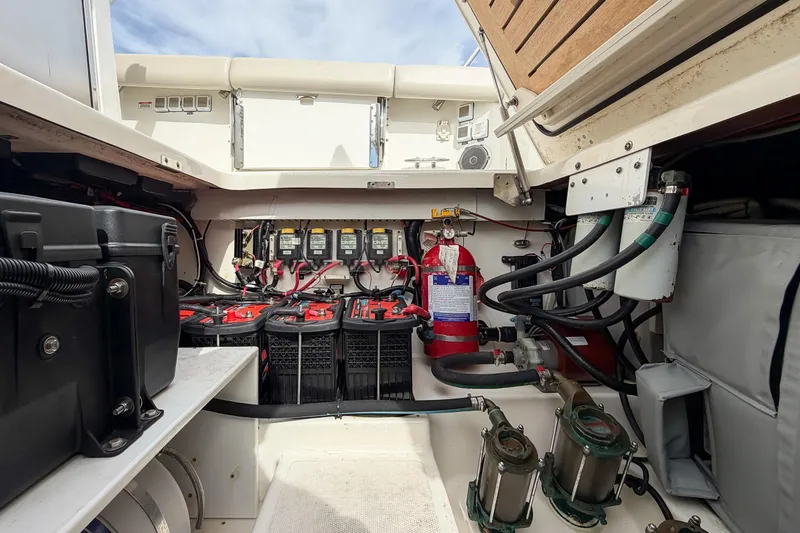 Slide: The Image of Engine compartment of 2018 Boston Whaler 420 Outrage with batteries and fire extinguisher. - 71