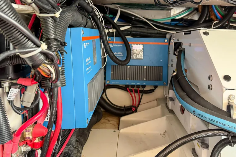 Slide: The Image of Engine room of 2018 Boston Whaler 420 Outrage with electrical components and wiring. - 73