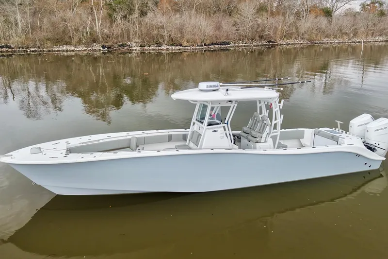 The Image of 2023 Cape Horn 34 XS boat on calm river, surrounded by trees. - 0