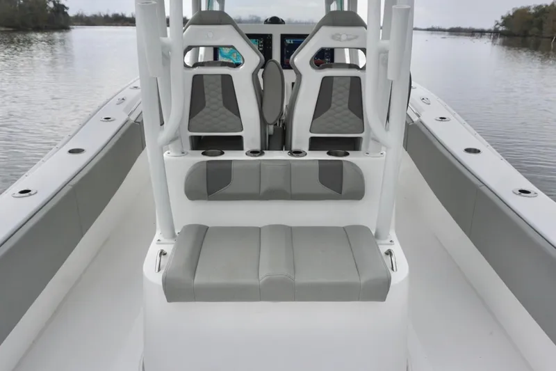 Slide: The Image of 2023 Cape Horn 34 XS boat interior with gray seating and console on calm water. - 10