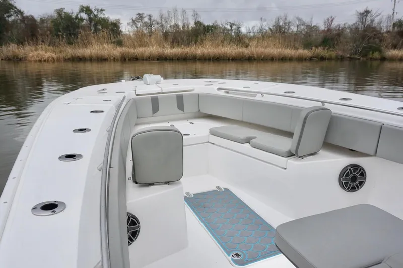 Slide: The Image of 2023 Cape Horn 34 XS boat interior with cushioned seating and speaker system. - 8