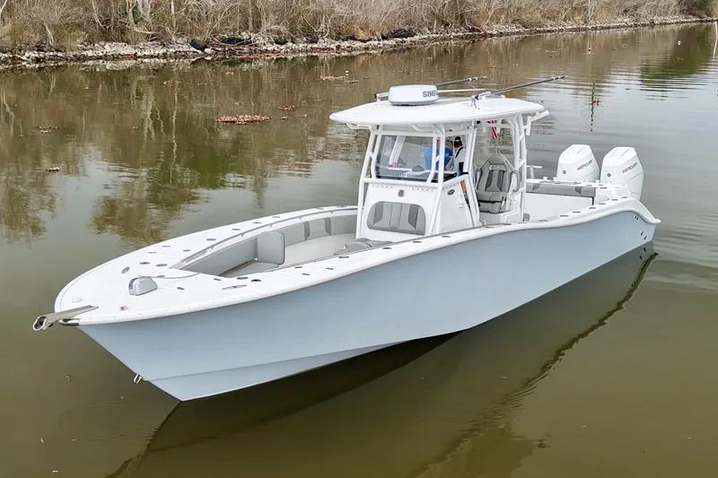 Slide: The Image of 2023 Cape Horn 34 XS boat on calm water, featuring dual engines and sleek design. - 1