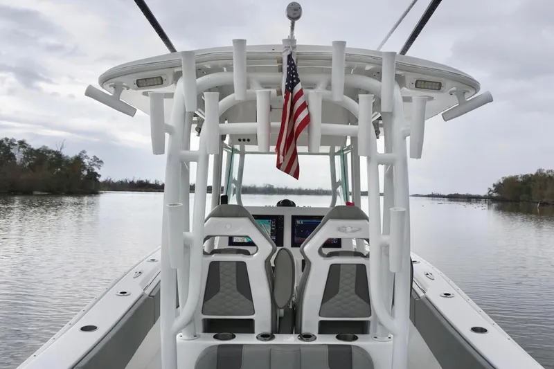 Slide: The Image of 2023 Cape Horn 34 XS boat with American flag on calm water. - 11