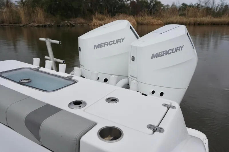 Slide: The Image of 2023 Cape Horn 34 XS boat with dual Mercury outboard engines on a calm waterway. - 19