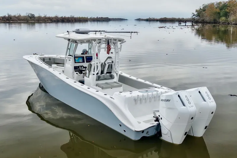 Slide: The Image of 2023 Cape Horn 34 XS boat with dual Mercury engines on calm water. - 3