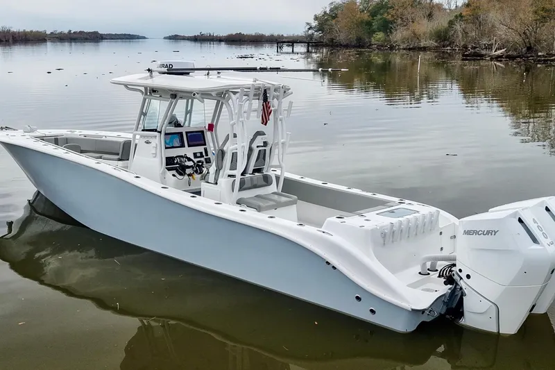 Slide: The Image of 2023 Cape Horn 34 XS boat on calm water, featuring dual Mercury engines. - 4