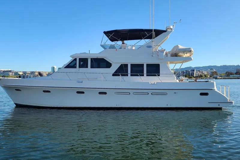 Slide: The Image of Luxury 2002 Symbol 58 yacht on calm water, clear blue sky background. - 3
