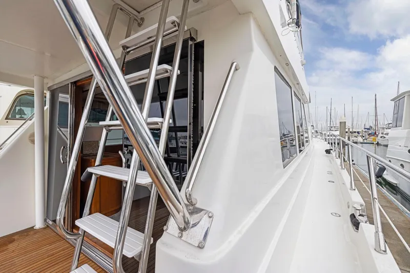 Slide: The Image of Luxury yacht deck with stainless steel ladder, Symbol 58 model, docked at marina, 2002. - 38