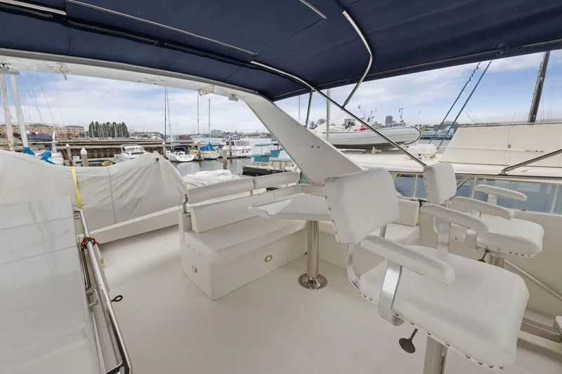 Slide: The Image of Luxurious 2002 Symbol 58 yacht interior with white seating and marina view. - 41