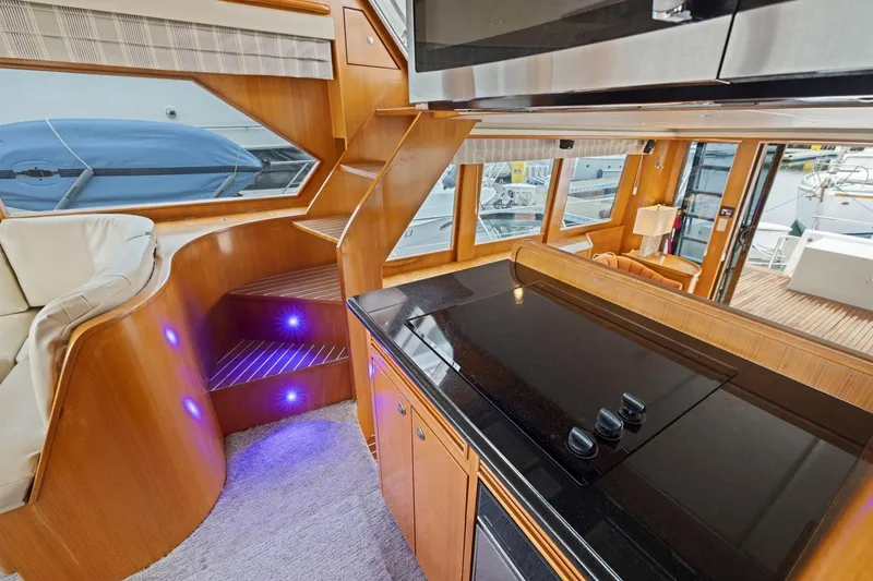 Slide: The Image of Luxurious interior of a 2002 Symbol 58 yacht with modern kitchen and elegant staircase. - 43