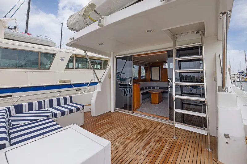 Slide: The Image of Luxury yacht deck with striped seating, wooden flooring, and interior view, Symbol 58, 2002 model. - 45