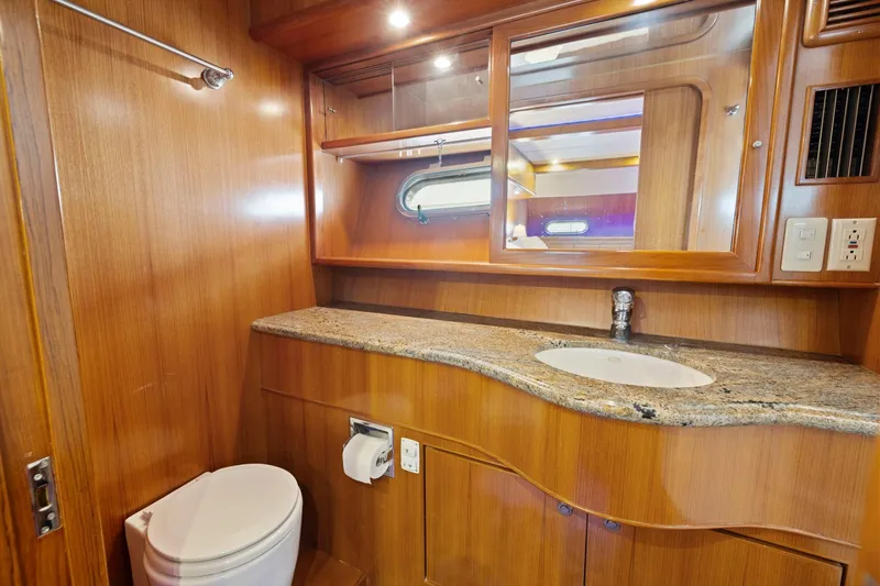 Slide: The Image of Luxurious yacht bathroom with wooden cabinetry, granite countertop, and modern fixtures, Symbol 58, 2002. - 46