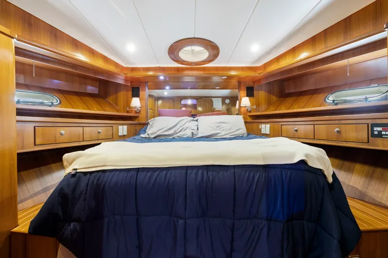 Slide: The Image of Luxurious yacht bedroom with wood paneling, cozy bedding, and ambient lighting, Symbol 58, 2002 model. - 47