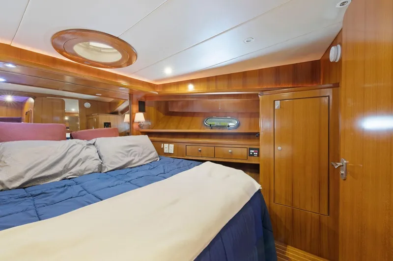 Slide: The Image of Luxurious wooden cabin interior of a 2002 Symbol 58 yacht with cozy bedding. - 50
