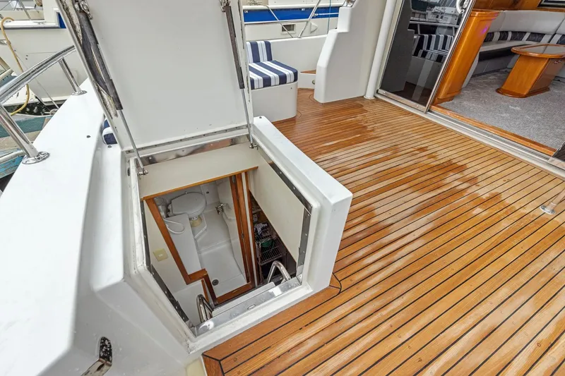 Slide: The Image of 2002 Symbol 58 yacht with open hatch revealing interior and wooden deck. - 52