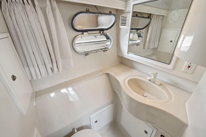 Slide: The Image of Compact boat bathroom with sink, mirror, and porthole window, Symbol 58 model, 2002. - 53