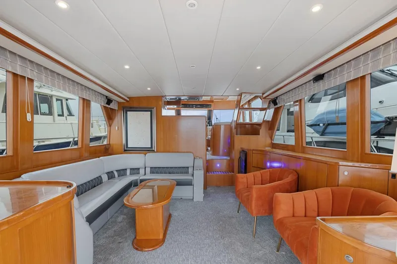 Slide: The Image of Luxurious 2002 Symbol 58 yacht interior with modern seating and wood paneling. - 8